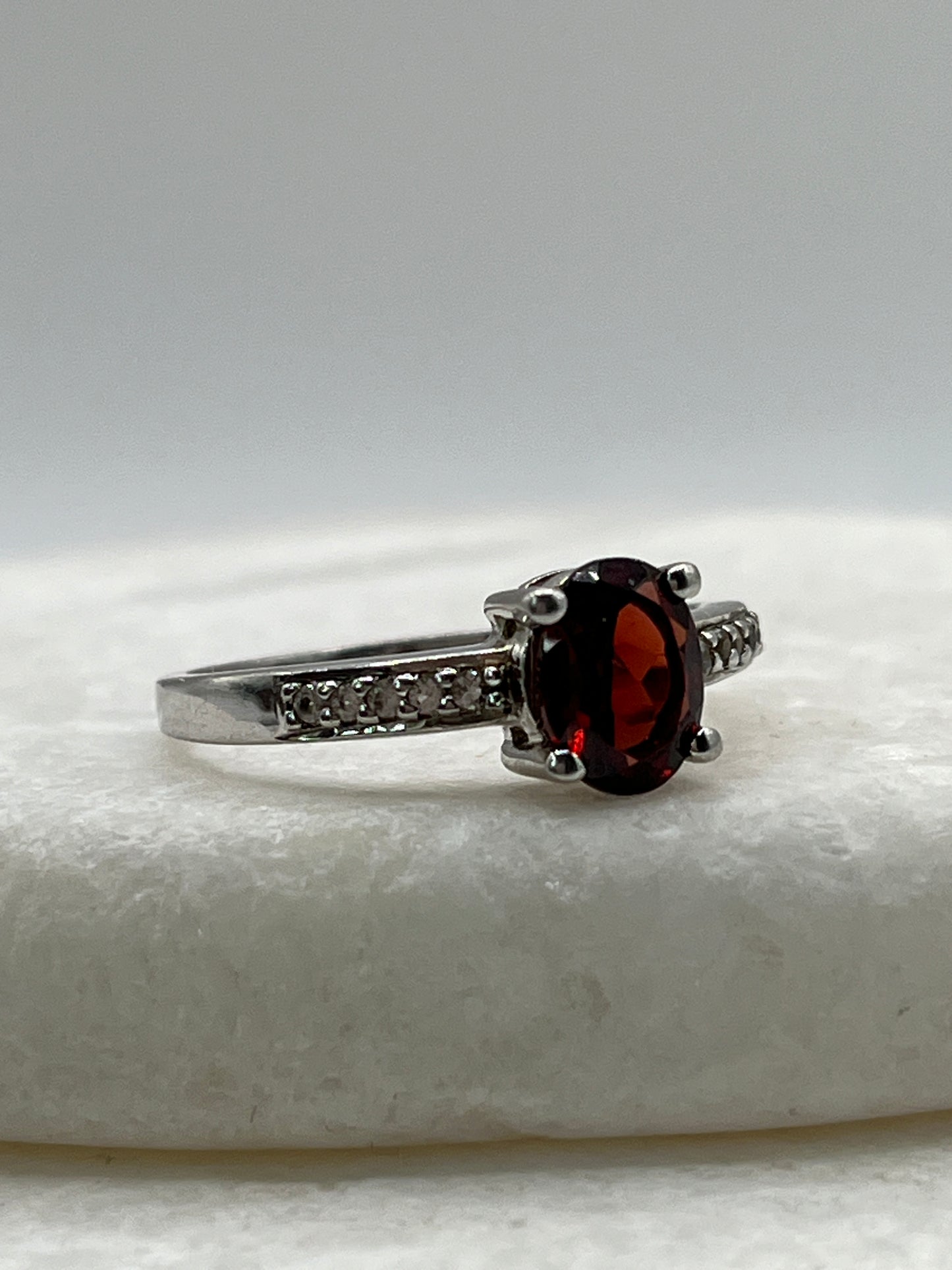925 Sterling Silver Garnet Ring with White Topaz Shoulders - Size S