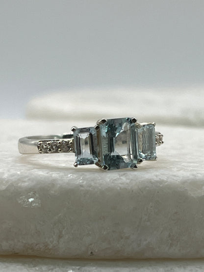 925 Sterling Silver Emerald Cut Aquamarine Trilogy Ring With White Topaz - Size Q